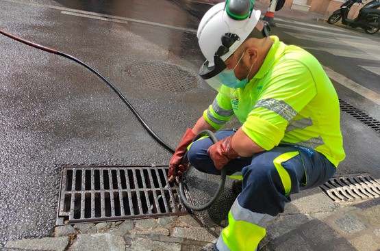 An operator cleans a scupper before the arrival of rains.